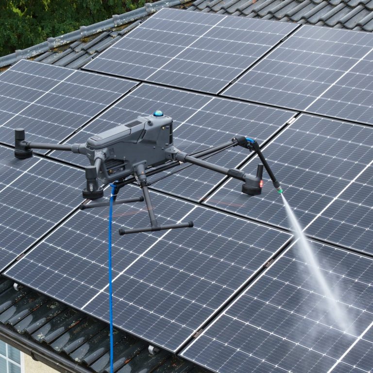 Drohnenreinigung Drohne reinigt Solarpanels auf einem Dach mit Wasserstrahl.